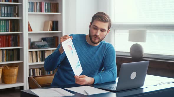 Young man conference calling by webcam. Focused young man holding video conference call alt