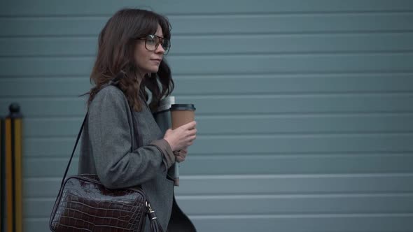 Slow Motion Profile of Business Woman in Eyeglasses with a Cup of Coffee