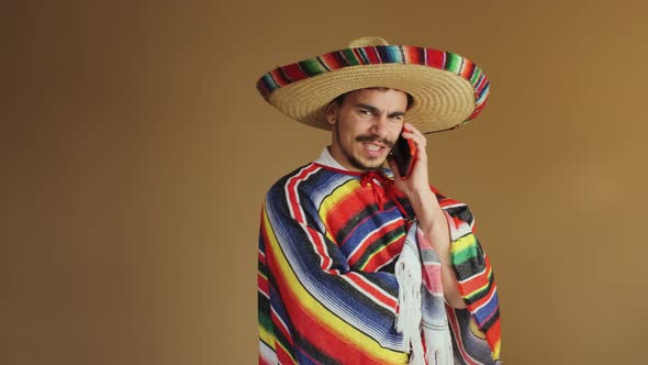 Young Mexican In Multicolored Poncho And Hat alt