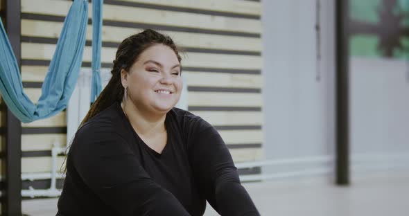 Happy Body Positive Woman Smiling and Laughing After Doing Stretching Exercise on Hammocks alt