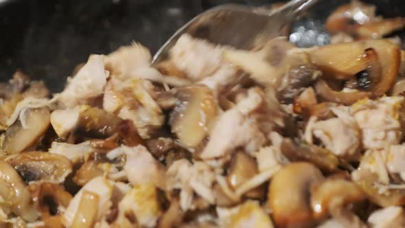 Mushrooms with Cheese and Meat Are Fried in a Pan in the Home Kitchen Julienne alt