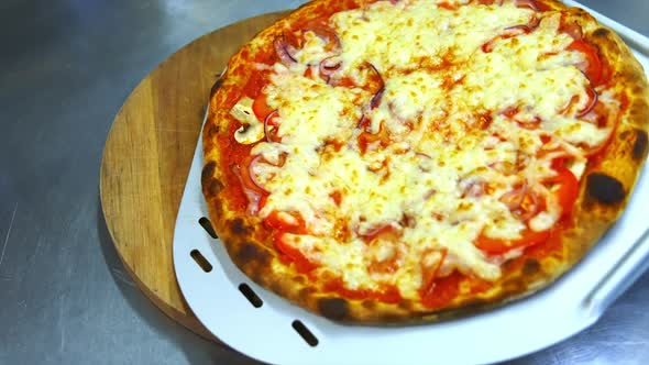 Hot yummy pizza with much cheese, bacon, tomatoes on top. alt