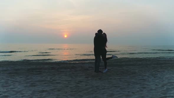 Passionate Couple Kiss During Romantic Sunset