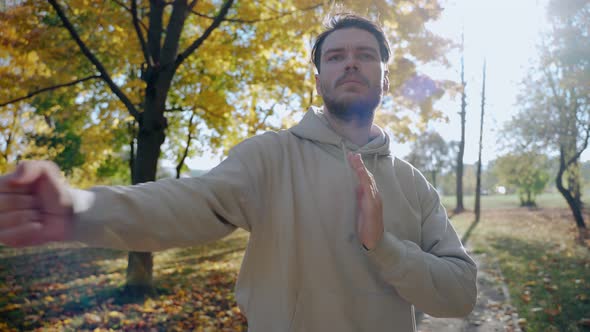 Handsome Man Exercising and Stretching Before Morning Run at the Park in Autumn alt