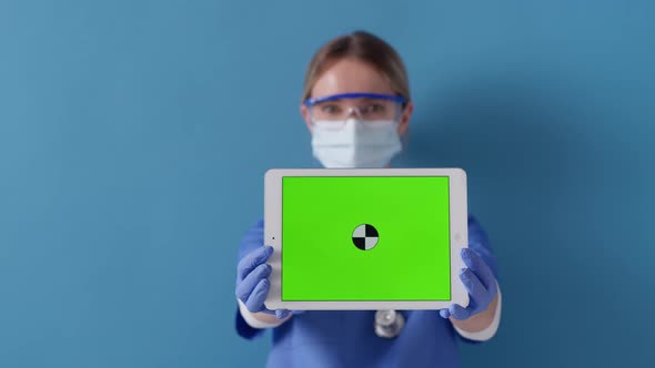 Nurde holding digital tablet with green screen. Concept of safety life