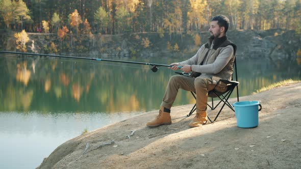 Attractive Young Angler Catching Fish Enjoying Healthy Activity Outdoors in River Bank alt