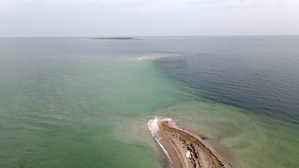 Bride at Uninhabited Sand Island in Ocean Reef,  Drone High Ungraded Video alt
