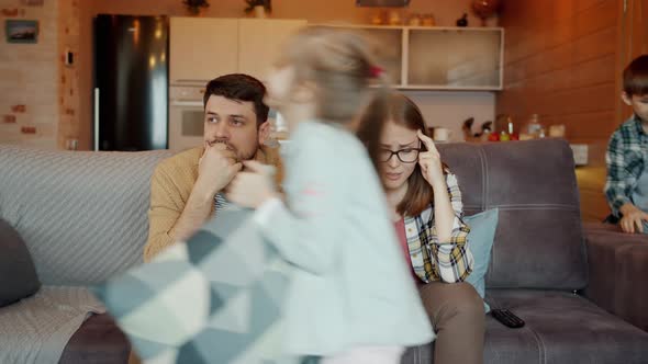 Fast Motion of Naughty Kids Running Around Having Fun While Parents Suffering From Headache Feeling alt