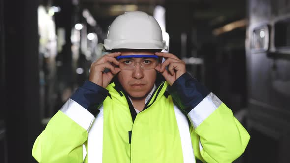 Portrait of Employee Serious Asian Man Engineer Worker Wearing Safety Uniform Looking at Camera