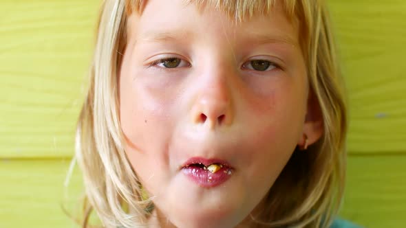 Blonde Girl Eats Cookies Portrait alt
