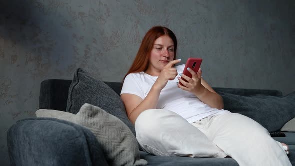 Woman Using Cell Phone in Living Room