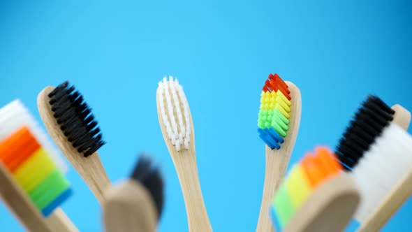Colorful Toothbrushes Is Spinning on Blue Background