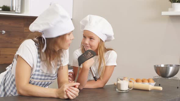 Thoughtful Woman and Daughter Dream About Baking alt