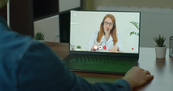 Man Video Chatting with Doctor. Tele Medicine Check Up From Home on Laptop Over the Internet. Male alt