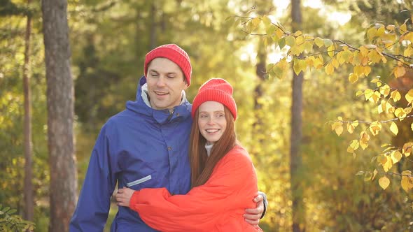 Portrait of Positive Caucasian Couple Relaxing in Autumn Forest alt