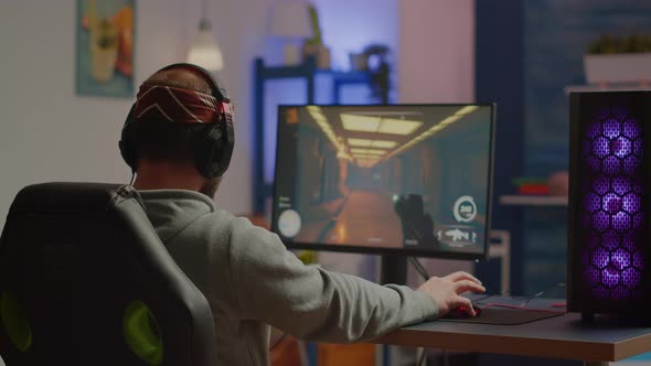 Back Shot of Happy Man Gamer Wining First Person Shooter Video Game alt