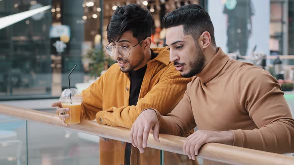 Two Positive Arab Guys Friends Students Stand in Public Place in Shopping and Entertainment Center alt