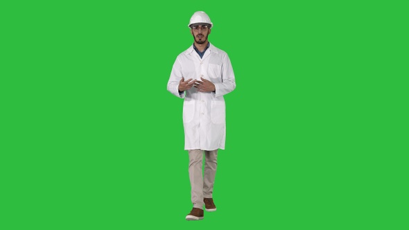 Arab engineer presenting something talking to camera while alt