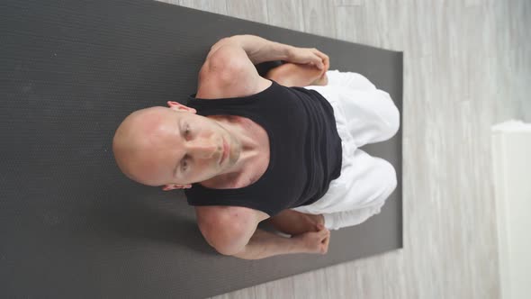 Experienced Bald Caucasian Yoga Man Doing Various Yoga Poses Indoors