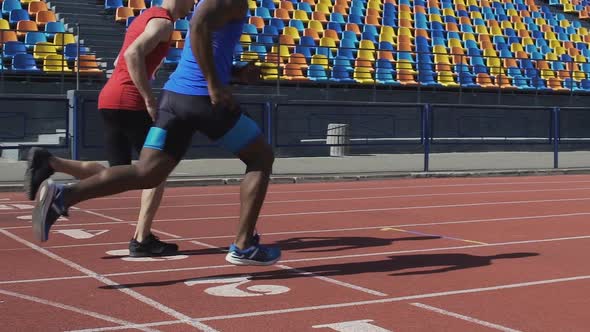 Sportsmen of athletic team training, running on sports field, marathon race alt