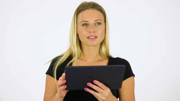 A Young Beautiful Woman Works on a Tablet - White Screen Studio alt