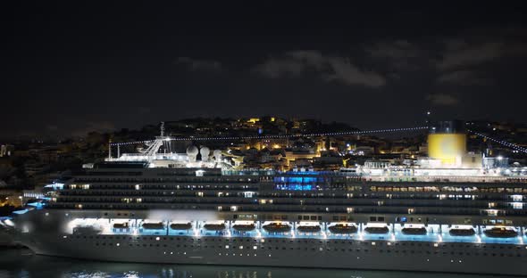 Aeial View. Big Cruise Ship with Lighted Lights Stands in the Port at Night alt