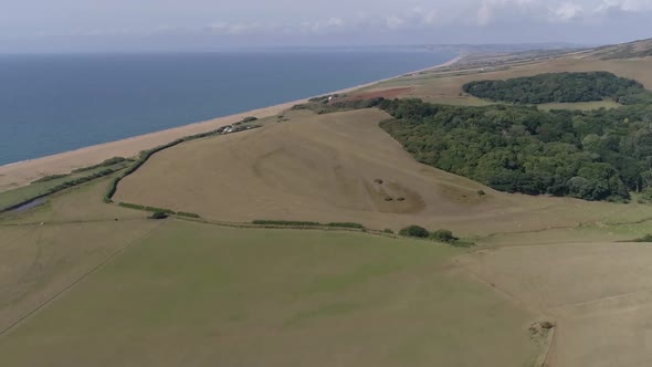 Aerial tracking high above the rolling fields of Dorset, amazing scenery as far as the horizon. shot alt