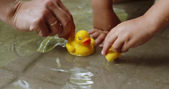 Mother and Child Play with Rubber Ducks alt