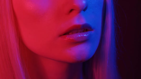 Shiny Juicy Female Lips in Neon Light