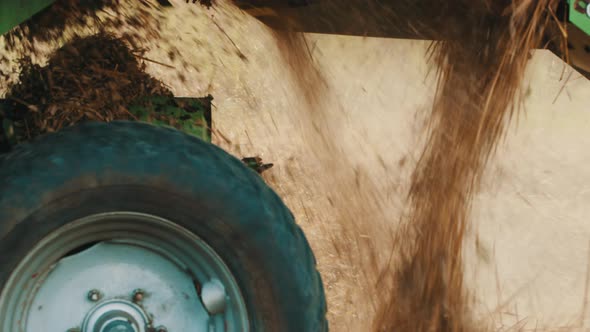 Hay Harvester Machine In An Agricultural Field During The Day Time  Dust Clouds alt