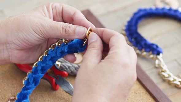 Closeup of Craftswoman's Hands Finishing Handmade Jewelry