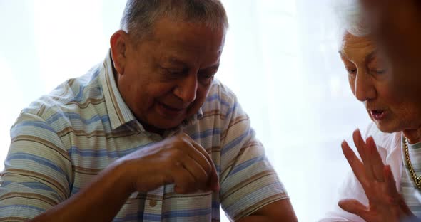 Senior citizen interacting while playing chess 4k alt