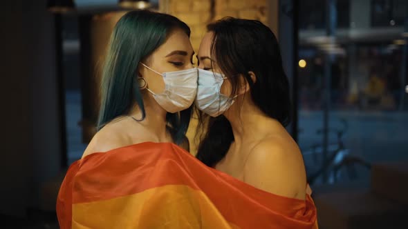 Two Naked Lesbian Women in Medical Masks with Rainbow Flag alt
