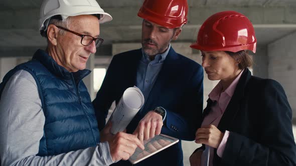 Static and close up footage of group of  caucasian engineers alt