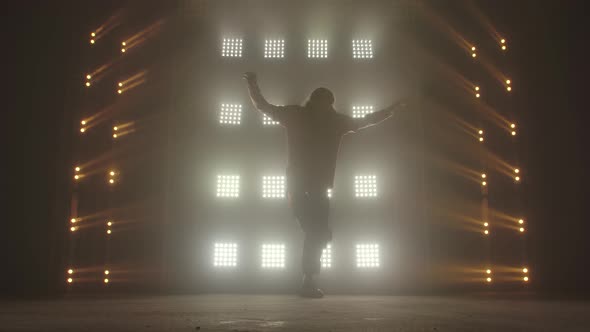Professional Young Hip-hop Dancer, Dancing in Dark Studio in the Green and Yellow Fog. Hip Hop alt