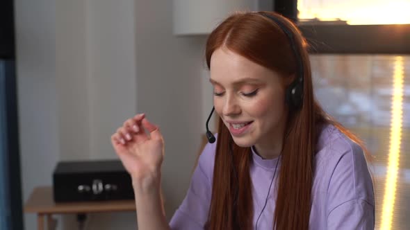 Closeup Face of Smiling Young Woman Operator Using Headset and Laptop Computer During Customer alt