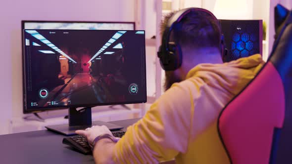 Over the Shoulder Footage of Man Playing Professional Video Games alt