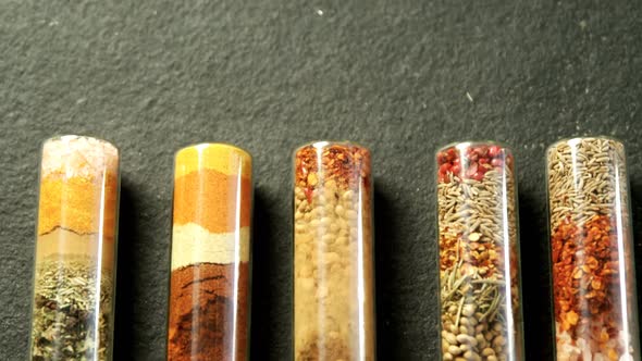 Various spices spilled out of jar 4k alt