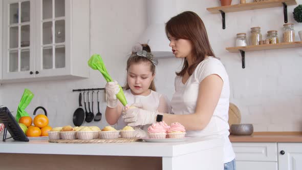 Mother and Daughter Icing Cupcakes