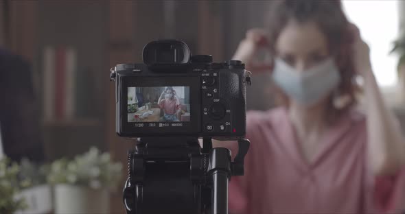 Vlogger With Medical Mask Filming In Room  Camera Closeup