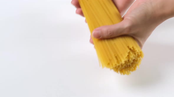 Spaghetti pasta falling on white background before cooking