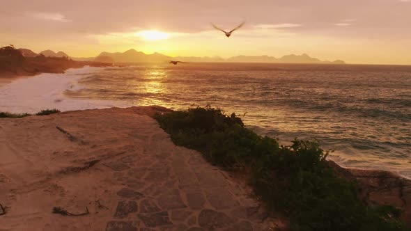 Tracking shot of cliff path overlooking ocean alt