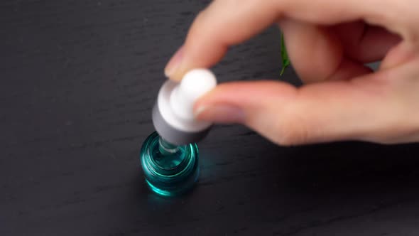 Moisturizing serum, vitamin for skin of face. A woman's hand alt