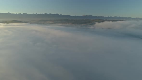 Heavenly scenery with sea of clouds during magical sunrise, aerial alt