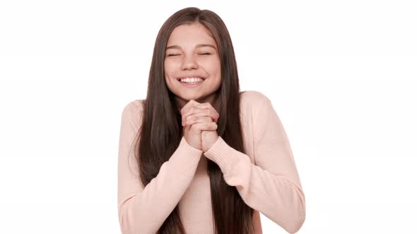 Portrait of Candid Woman with Brown Long Hair Looking Up with Keeping Hands in Praying Pose Begging alt