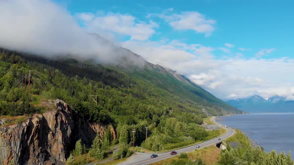 4K Drone Video of Alaska Route 1 at Base of Mountain Along Shoreline of Turnagain Inlet Near Anchora alt