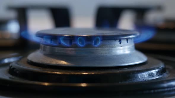 Close-up of Turning On a Kitchen Gas Stove alt