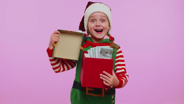 Cheerful Girl Christmas Santa Claus Elf Getting Present Gift Box Expressing Amazement Happiness alt