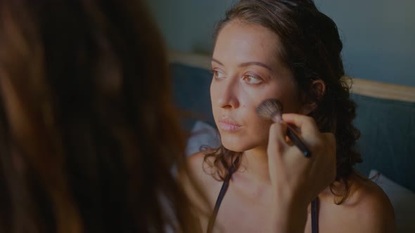 A Makeup Artist Makes a Bright Makeup for a Beautiful Girl Model alt