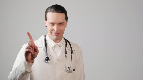 The Young Male Doctor Shows a Hand Gesture and Shakes His Finger To the Sides